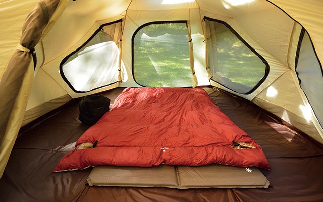 rectangular shaped sleeping bag inside a roomy camping tent