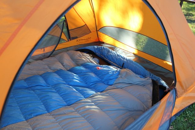 blue and gray sleeping bag inside a tent